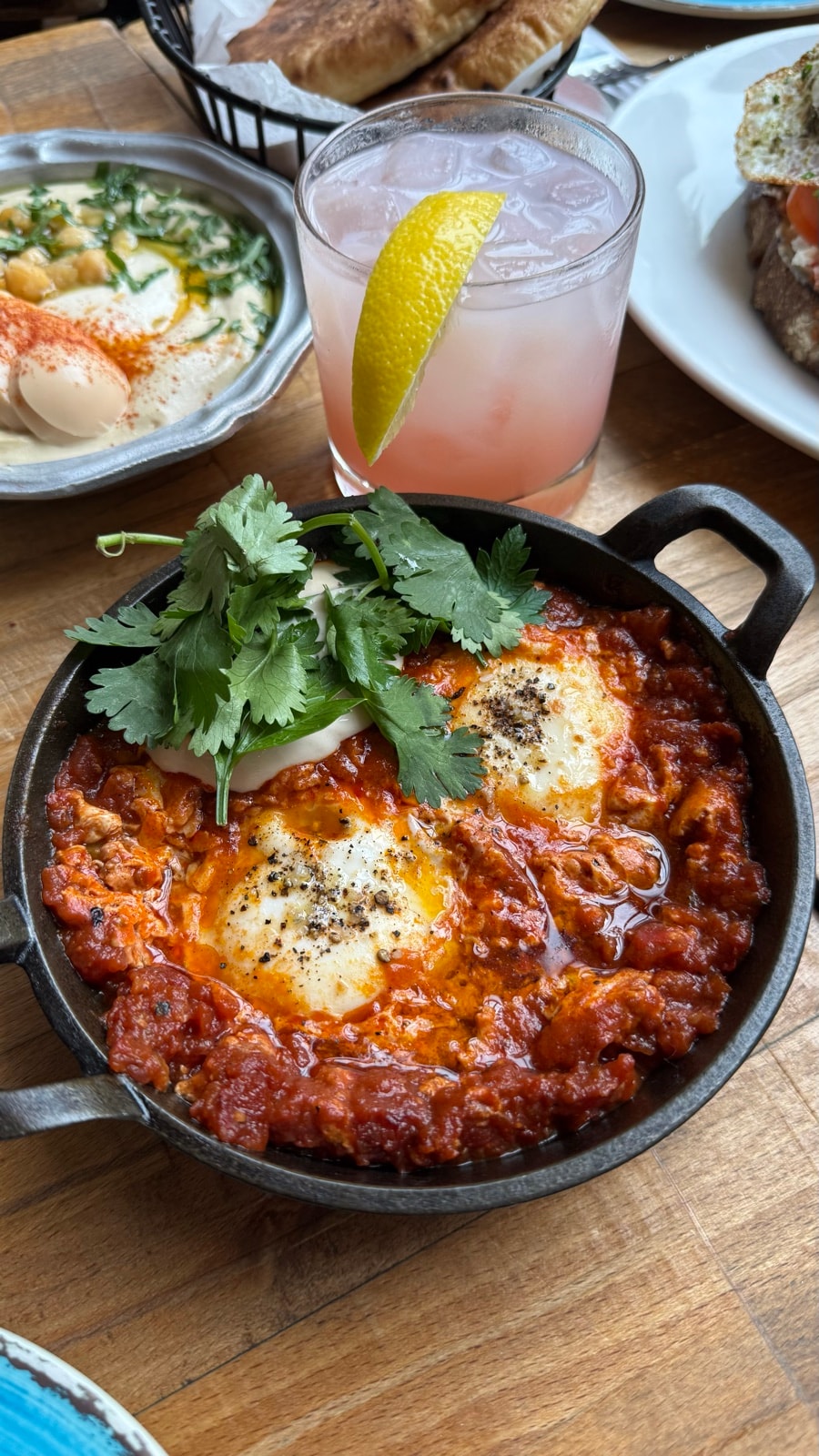 Shakshuka in a cast-iron pan with a spritz